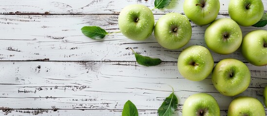Aufkleber - A flat lay composition featuring fresh ripe green apples placed on a white wooden table with ample copy space image included