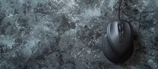 Poster - Top down view of a wired mouse on a grey textured table with available space for text overlay in the image. Creative banner. Copyspace image