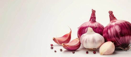 Poster - Isolated on a white backdrop garlic Allium Sativum and red onion Allium cepa L are present in the image with copy space
