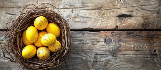 Aufkleber - Celebrate Easter with vibrant yellow eggs in a nest on a wooden table a creative top view decoration Enjoy the festive vibe with a copy space image