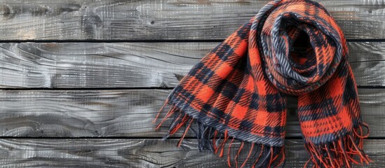 Poster - Checkered scarf on wood surface with gray background ample copy space image
