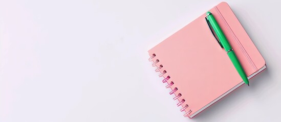 Aufkleber - Minimalist top down view of a delicate pink notebook with a vibrant green pen resting on a blank white surface suitable for school or office themed backgrounds featuring a flat lay composition with a