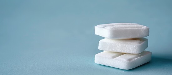 Aufkleber - A stack of sugar substitute tablets on a blue backdrop with room for a copy space image serving as an alternative to traditional sugar