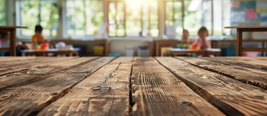 Poster - Wooden table with a blurred school classroom background creates copy space for product placement amidst a picturesque school setting