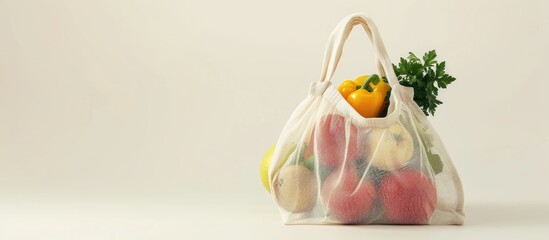 Poster - Eco friendly cotton mesh bag with fruits and vegetables promoting a sustainable lifestyle and zero waste shopping with a focus on recycling in a copy space image