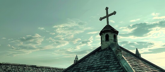 Poster - A cross depicted on the roof of a church with copy space image available
