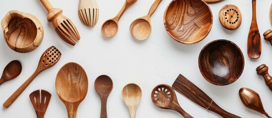 Sticker - Kitchen utensils and bowls made of wood arranged neatly on a white surface from a bird s eye view in a kitchenware collection with a copy space image