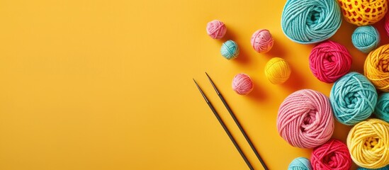 Poster - Knitting supplies like needles yarn balls and a crochet hook displayed on a bright yellow backdrop providing a cheerful copy space image