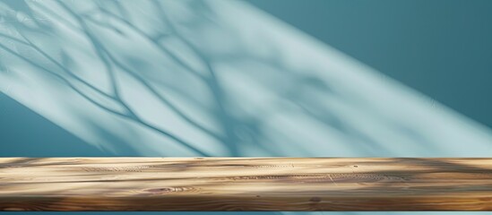 Fototapete - Wooden table with no items on top set against a blue wall ideal for showcasing products or ads Ideal as a template for product display with copy space image potential
