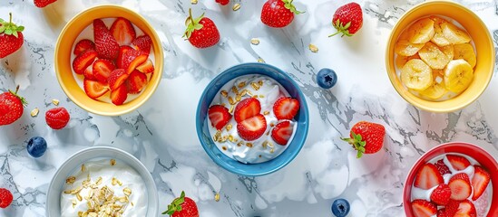 Aufkleber - Flat lay with breakfast bowls of fresh fruits yogurt porridge and whole strawberries on a marble table with copy space image