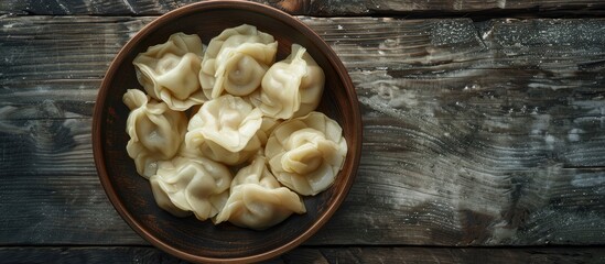 A restaurant setting displays a plate of freshly cooked Georgian Khinkali dumplings with empty space for text or other design elements in the image. Creative banner. Copyspace image