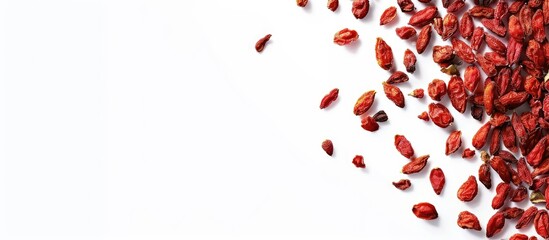 Poster - Top down view of dried goji berries on white backdrop with copy space image for text arranged in a flat lay style
