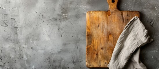 Poster - Top down view of cutting board with a napkin presented on a concrete surface creating a sleek and professional aesthetic with copy space image