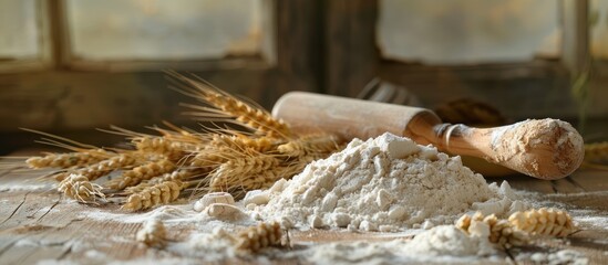 Poster - Wooden table adorned with a pile of flour a rolling pin ears of wheat and ample copy space for images all creating a rustic culinary setting