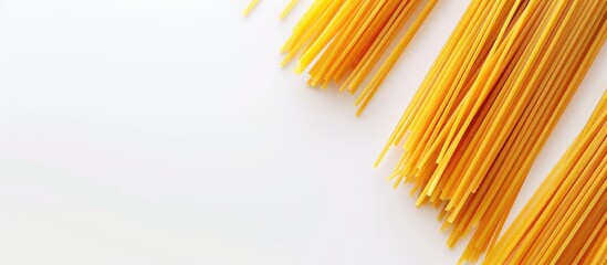 Poster - Top view of uncooked spaghetti on a white backdrop with space for adding images known as a copy space image