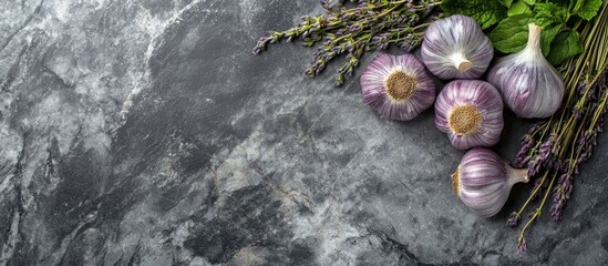 Poster - French dried violet garlic and fresh garden herbs on a granite board. with copy space image. Place for adding text or design