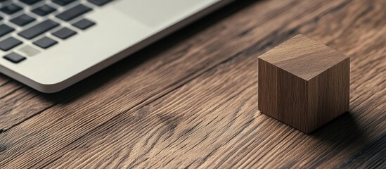 Wall Mural - plain wooden cube on a laptop with a selective focus on the wooden block on the keyboard. with copy 
