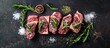 © vxnaghiyev - Fresh meat Raw beef steaks with rosemary and spices arranged on a sleek blackboard Flat top view. with copy space image. Place for adding text or design