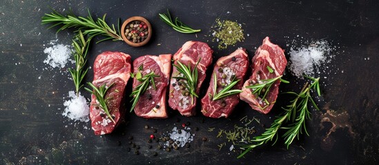 Aufkleber - Fresh meat Raw beef steaks with rosemary and spices arranged on a sleek blackboard Flat top view. with copy space image. Place for adding text or design