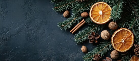 Fototapete - Christmas backdrop featuring fir branches spices nuts and dried orange slices Vertical top view with copy space