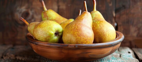 Fototapete - Ripe pears in a bowl on a wooden table. with copy space image. Place for adding text or design