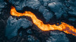 © alexandra_pp - Top-down aerial shot of a glowing orange lava river flowing between dark, textured volcanic rock, capturing the raw and dynamic contrast of molten lava against the cooled surface.