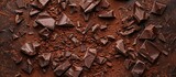 Crushed dark chocolate pieces and cocoa beans culinary backdrop top view. with copy space image. Place for adding text or design