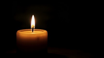 Poster - A single solitary candle flame burning amidst the darkness casting a warm cozy glow with ample copy space for text or design overlay