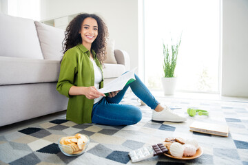 Wall Mural - Photo of adorable charming girl sit floor carpet hold read book homework lecture education from home living room indoors