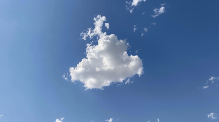 Wall Mural - A cloud shaped like a heart is floating in the sky. The sky is blue and clear, with no clouds in the foreground