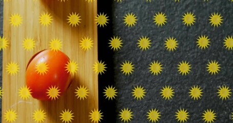 Wall Mural - Yellow star patterns animation over tomatoes on wooden and dark surfaces