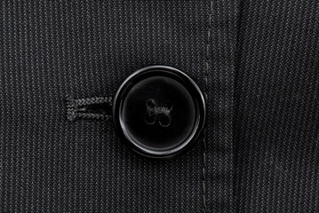 Close-up of a button on a men's blue suit. Button on a suit