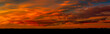 © Designpics - Panoramic of colorful red and orange cloud formations creating a dramatic sky at twilight with a silhouetted horizon; Calgary, Alberta, Canada