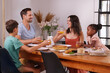 © Caia Image - Family enjoying meal together