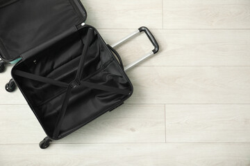 Poster - Open empty suitcase on floor indoors, top view. Space for text