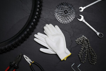 Sticker - Flat lay composition with different bicycle components, tools and gloves on dark gray textured background