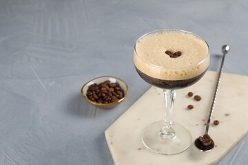 Sticker - Fresh coffee cocktail in glass, beans and mixing spoon on grey table, space for text