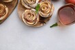 © New Africa - Freshly baked apple roses, ingredients and tea on light table, flat lay. Space for text