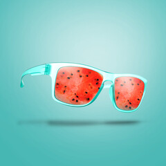 Wall Mural - Sunglasses with juicy watermelon in air on turquoise background. Summer vibe