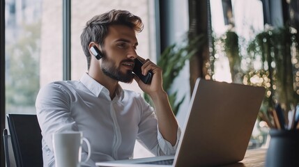 Poster - professional man engaged in a phone call while working on a laptop in a modern office setting during