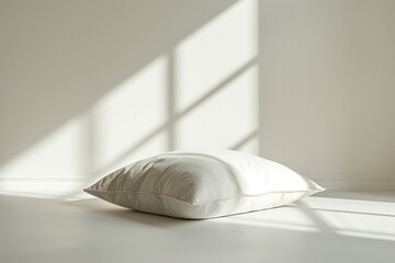 Poster - A white pillow sits on a white floor in a room with a window