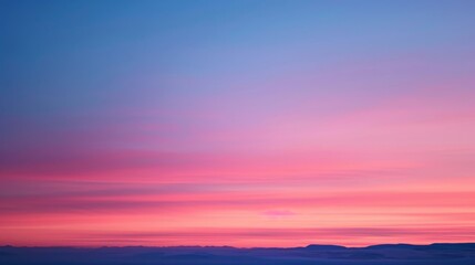 Aufkleber - A stunning gradient of sunset colors spreads across the sky, with deep reds and soft pinks blending seamlessly into the twilight blue.