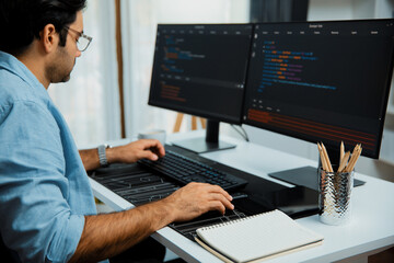 Smart IT developer working software development coding with creating application program update version online website on data's company system two computer code pc screen at modern office. Surmise.