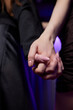 © Евгений Вершинин - A Couple Enjoying Each Others Company While Holding Hands in a Lively Nightclub Setting