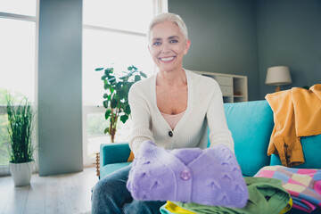 Sticker - Photo of adorable cute retired woman dressed white cardigan cleaning home tidy clean fresh clothes indoors