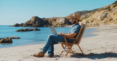 Poster - Male digital nomad sitting in beach chair on the shore, working with laptop and looking at ocean, wearing blue jeans shirt and straw hat, relaxed pose, side view, cinematic style.