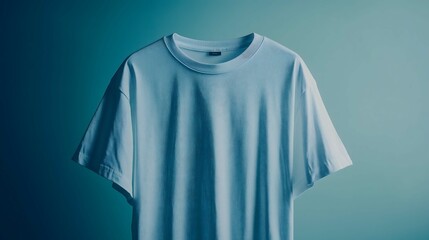 Minimalist light blue t-shirt hanging on turquoise background