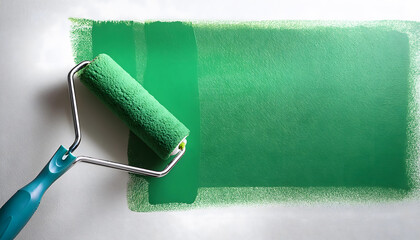 A green paint roller is being used to paint a wall