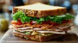 © ANC Media - A delicious sandwich layers turkey slices, fresh greens, and tomatoes on hearty whole grain bread