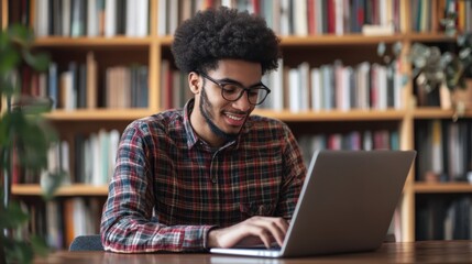 Wall Mural - Young man student study at home using laptop and learning online